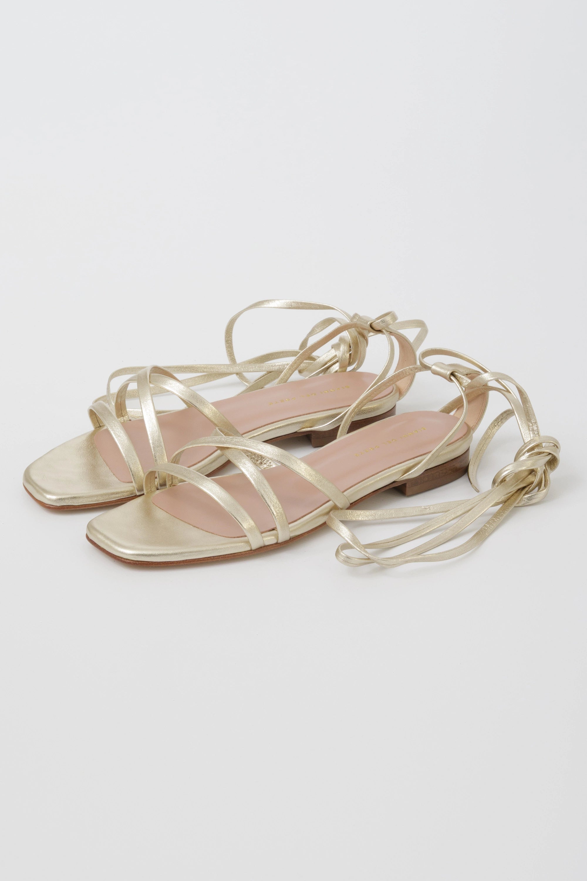 Flat platinum laminated gladiator sandal